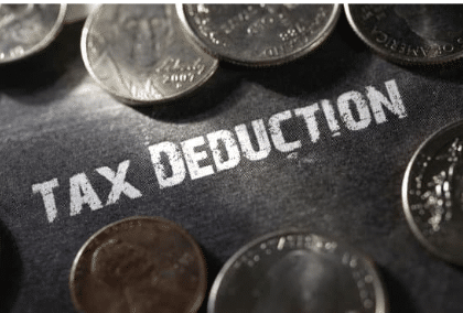 Image depicting money with the words tax deduction, to illustrate that this article is about section 179 deduction